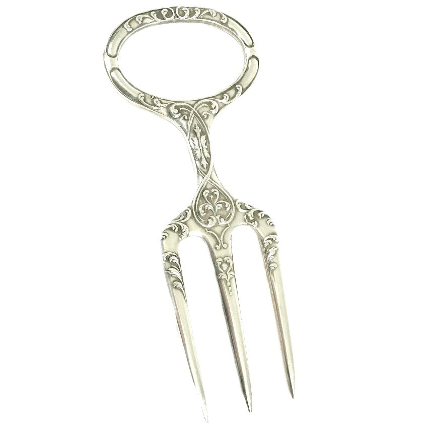 Antique Sheffield Silver Plate Meat or Game Carving Fork with a traditional trident three tine prong end and a circular handle decorated with intricate art nouveau design.