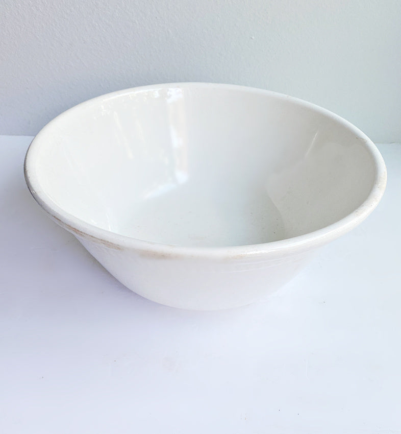 Vintage ironstone bowl with warm patina, the kind that anchors a kitchen with simple, lasting character