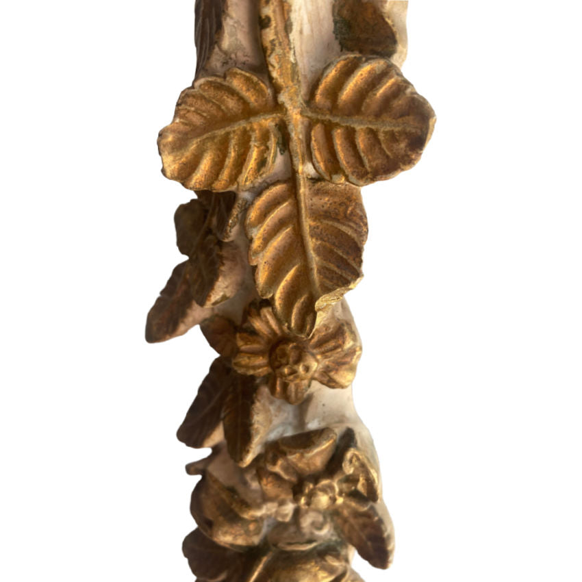 Close-up of Hollywood Regency style column lamp with gold gilt finish and sculpted rose garlands in plaster with leaf tip loss detail