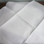 heirloom linen napkins with scrolling bourdon embroidery
