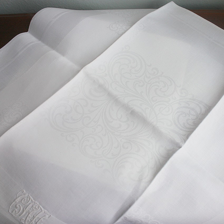 heirloom linen napkins with scrolling bourdon embroidery