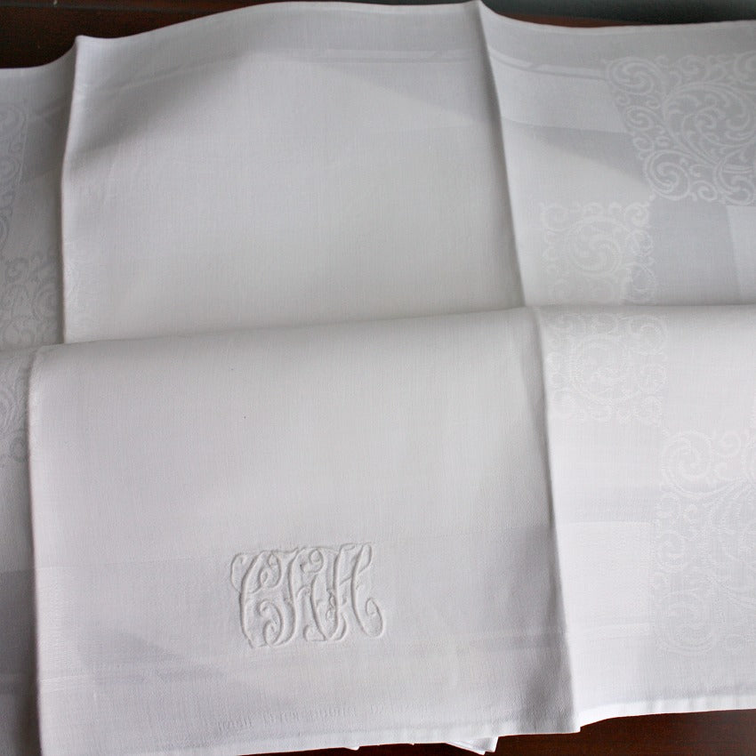 antique white linen napkins styled on elegant table setting
