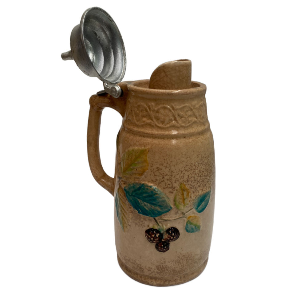 Detail of botanical relief on 1875 Edwin Bennett majolica pitcher wth spout and lid