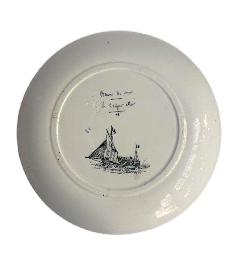 Reverse of antique 19th century French faience plate showing glaze and Creil Montereau mark of sail boat