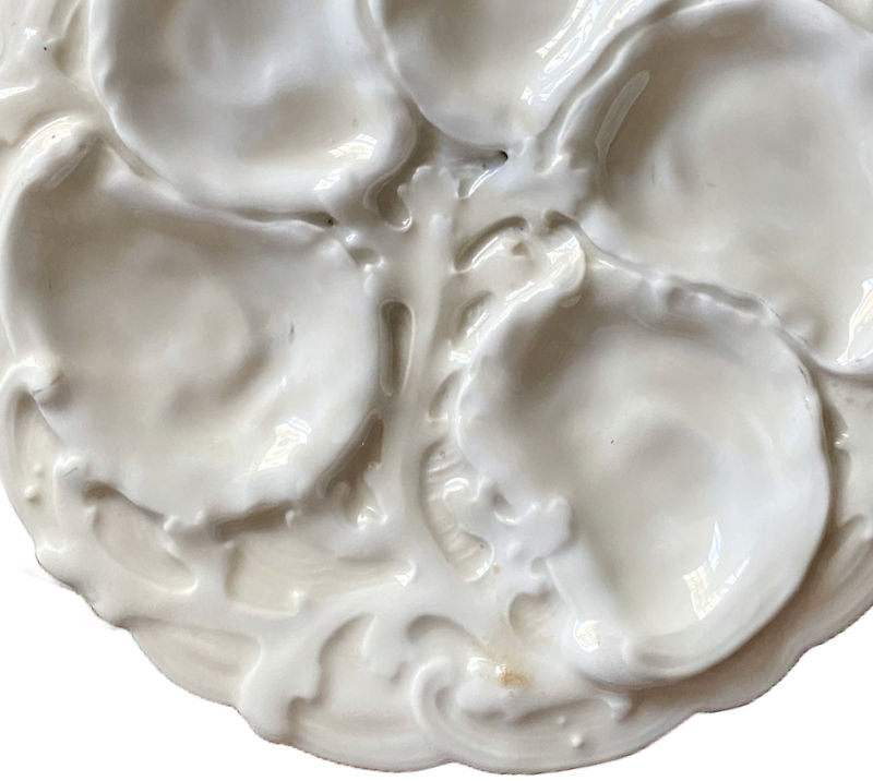Rare 19th century French Limoges oyster plate in all-white relief porcelain. Elegant antique French tableware for collectors and refined display.
