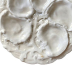Rare 19th century French Limoges oyster plate in all-white relief porcelain. Elegant antique French tableware for collectors and refined display.