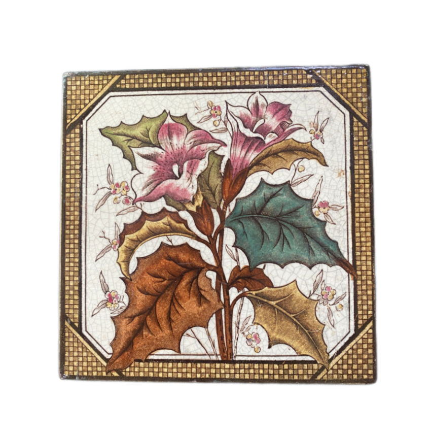 Antique aesthetic hand-painted ceramic tile with a floral design, featuring pink lilies, green and brown leaves, and brown basket weave border.