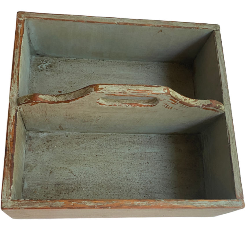 Interior view of antique wooden work box with softened green finish and natural wood grain