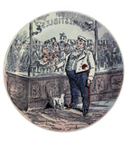 Front view of 19th-century Creil-Montereau faience plate showing interior shop scene with a cat and crowds peering at the window display from outside.