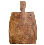 Antique French hand-carved wooden cutting board with a dark patina and a short handle.
