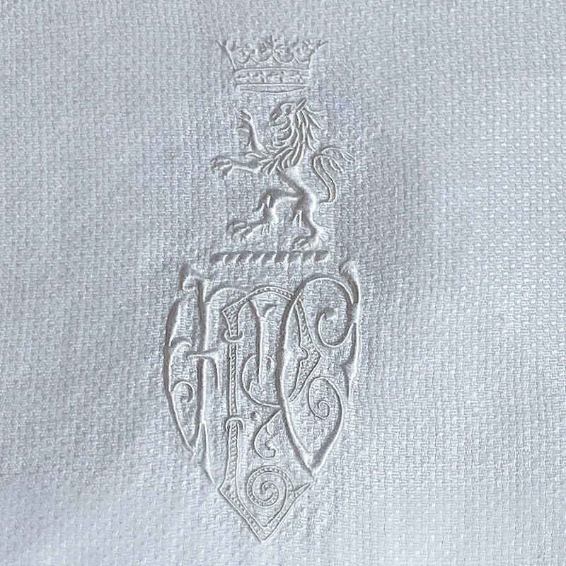 Antique French hand-embroidered towel with crowned lion monogram and lace trim—noble 19th-century linen with exquisite detail and timeless elegance.