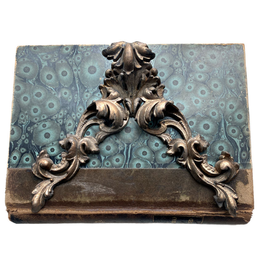 19th century french pediment ornament salvage decor in gilded metal on an antique book