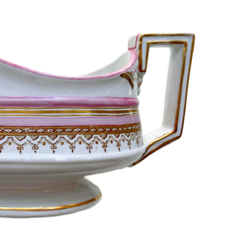French porcelain sauce boat with pink painted accents and gold border decoration handle view