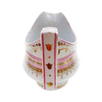 Close up view of handle with gilt decorations on antique French porcelain sauce boat