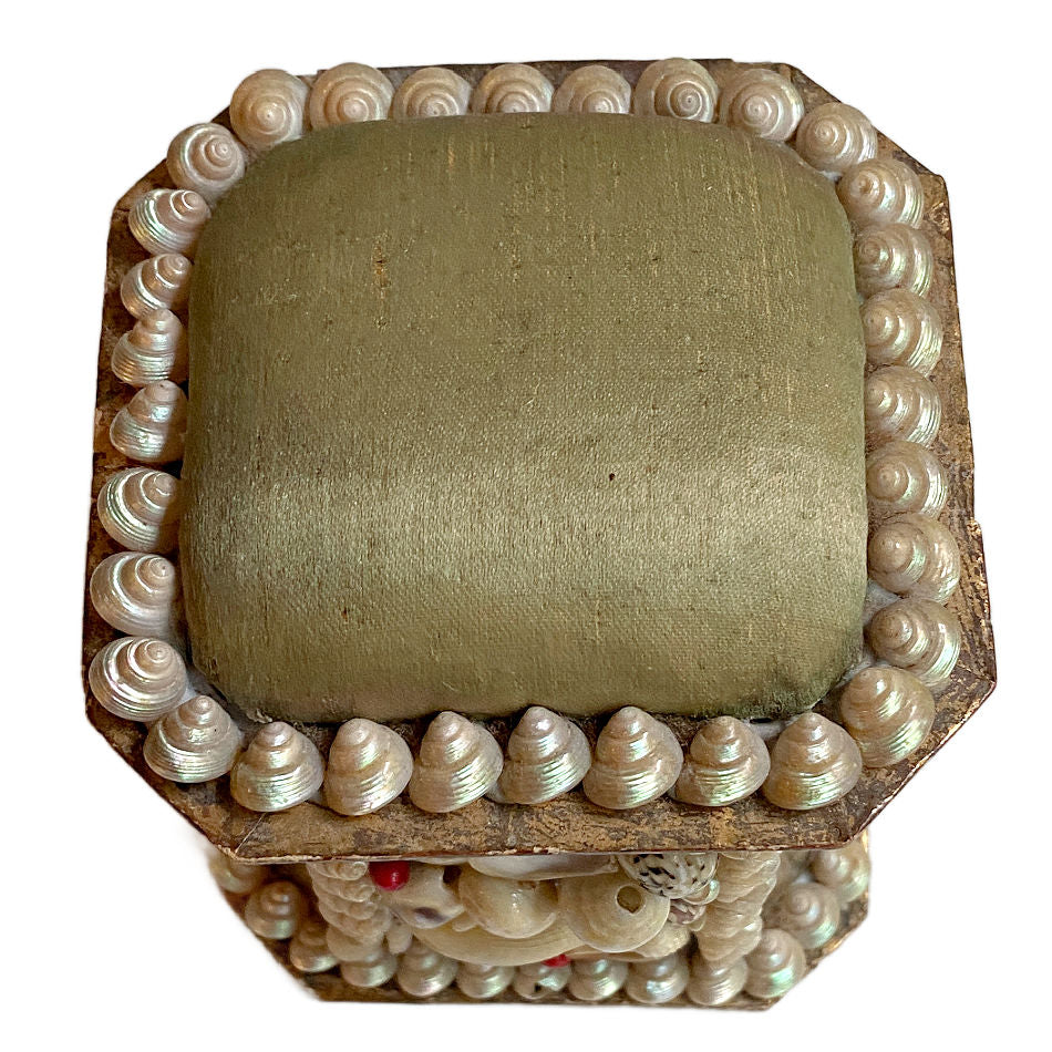 Top view of antique French shellwork souvenir box with green silk
