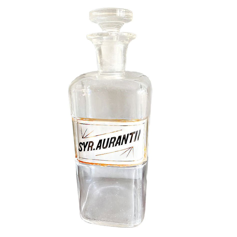 Antique glass apothecary bottle with Syrup Aurantii label under glass
