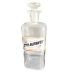 Antique glass apothecary bottle with Syrup Aurantii label under glass