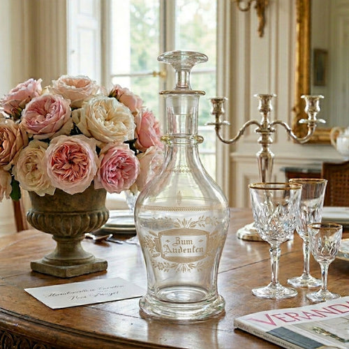 Antique Bohemian friendship gift decanter styled on a French dining table with crystal glassware and floral arrangement