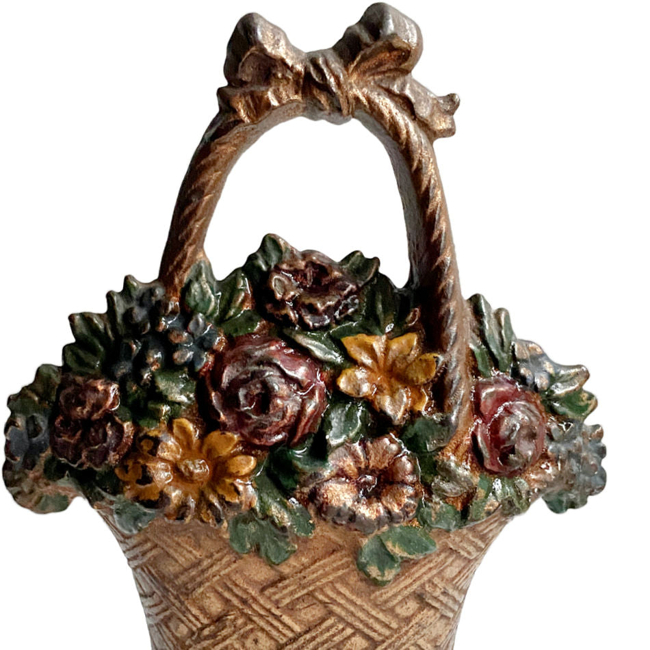 Close-up of antique Hubley doorstop painted surface and gold bow