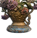 Cast iron floral urn doorstop with plum and gold painted surface base view