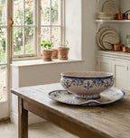 Antique Moustiers faience sauce boat with in a country kitchen with light streaming in, on an antique French table