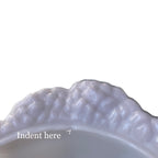 Side view of lilac opaline cabbage bowl highlighting sculpted cabbage leaf form and luminous glass finish close up