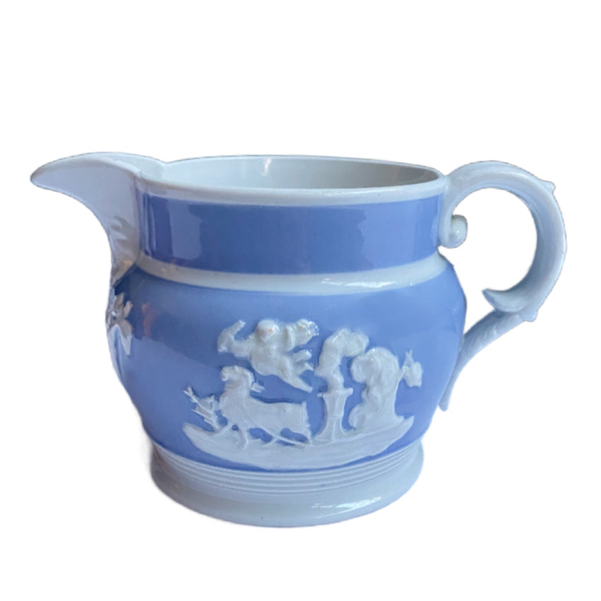 Antique English Staffordshire pearlware jug by Chetham &amp; Woolley, c.1820–30, with classical jasperware-style relief figures. 5 inches high.