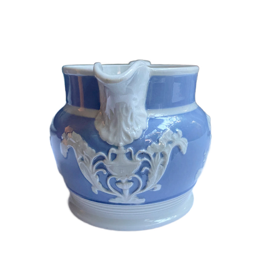 Antique English Staffordshire pearlware jug by Chetham &amp; Woolley, c.1820–30, with classical jasperware-style relief figures. 5 inches high.