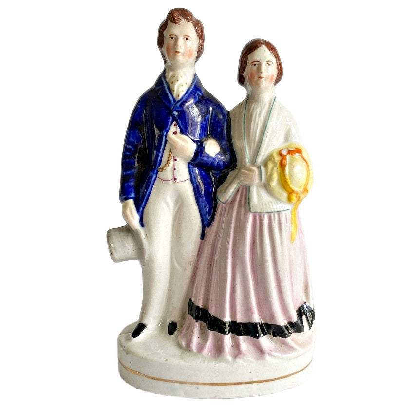 Antique Staffordshire prince and princess figurine with blue coat and pink dress