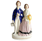 Antique Staffordshire prince and princess figurine with blue coat and pink dress