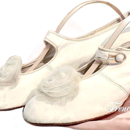Rare antique white leather bridal shoes adorned with ethereal chiffon roses. Romantic historic wedding footwear, beautifully preserved.