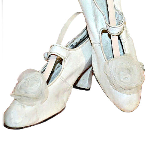 Rare antique white leather bridal shoes adorned with ethereal chiffon roses. Romantic historic wedding footwear, beautifully preserved.
