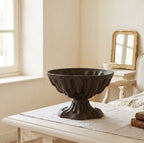 Victorian cast iron urn used as a decorative planter in a light-filled interior