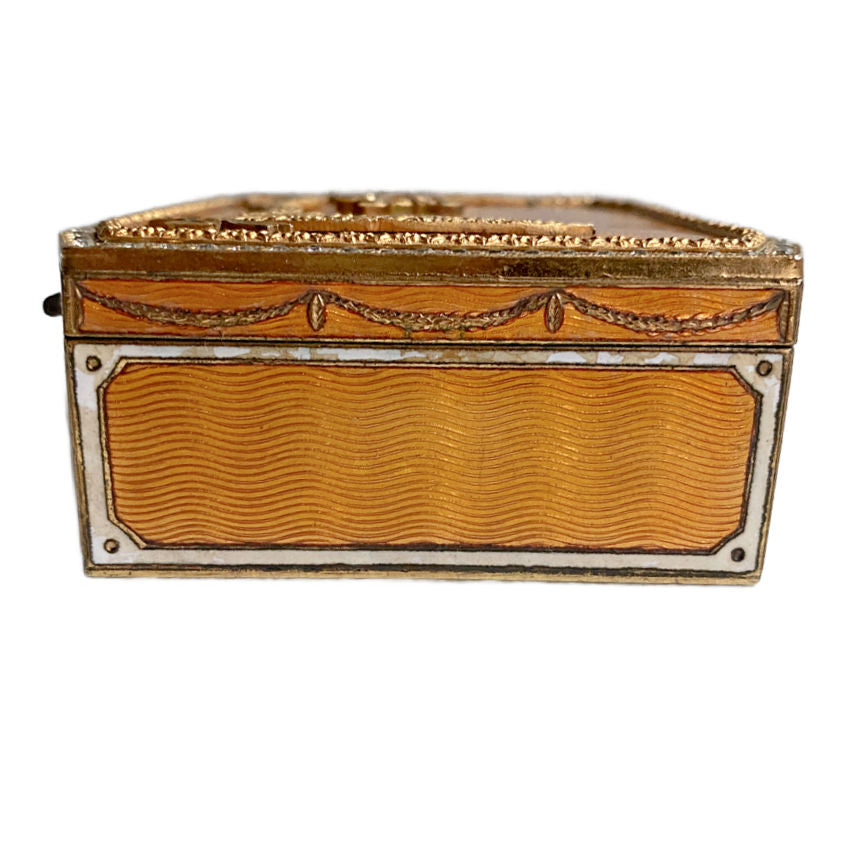 Side view showing guilloché enamel and gilt-metal decoration