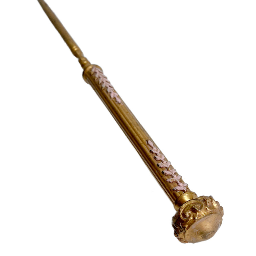 Close-up detail of pink enamel decoration on Apollo Studios gold-plated button hook