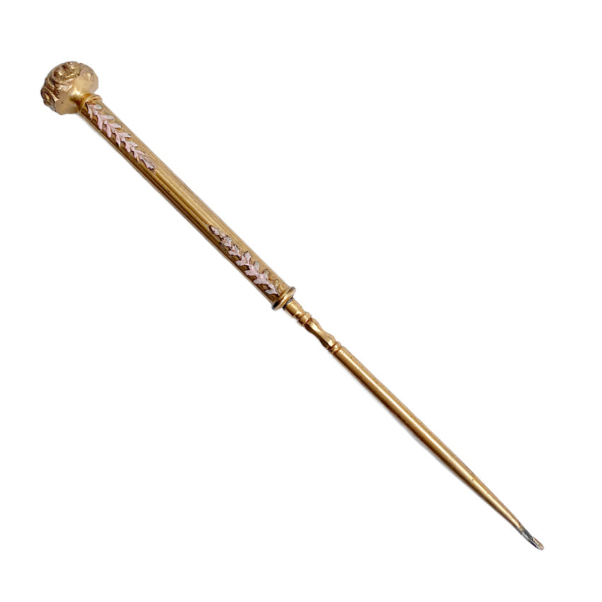 Elegant antique button hook by Apollo Studios showing gold-plated finish and enamel detail