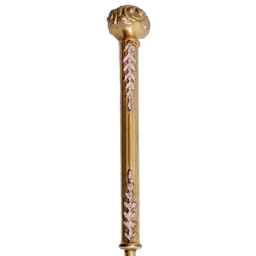 Decorative antique gold-plated button hook with pink enamel, collectible accessory detail