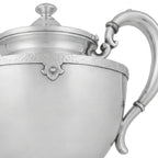 Antique Art Deco silver teapot with rounded body, long curved spout and stepped lid detail