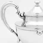 Antique Art Deco teapot in silver plate with graceful curved handle and spout