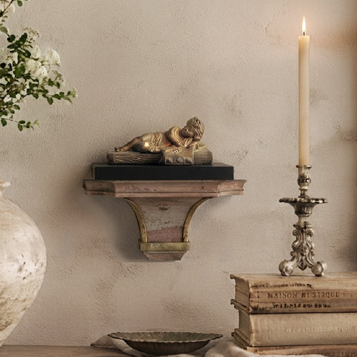 Antique Beaux Arts gilt bronze cherub sculpture styled with French books, white flowers, and candlelight