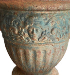 Heavy European cast iron urn with sculptural faces