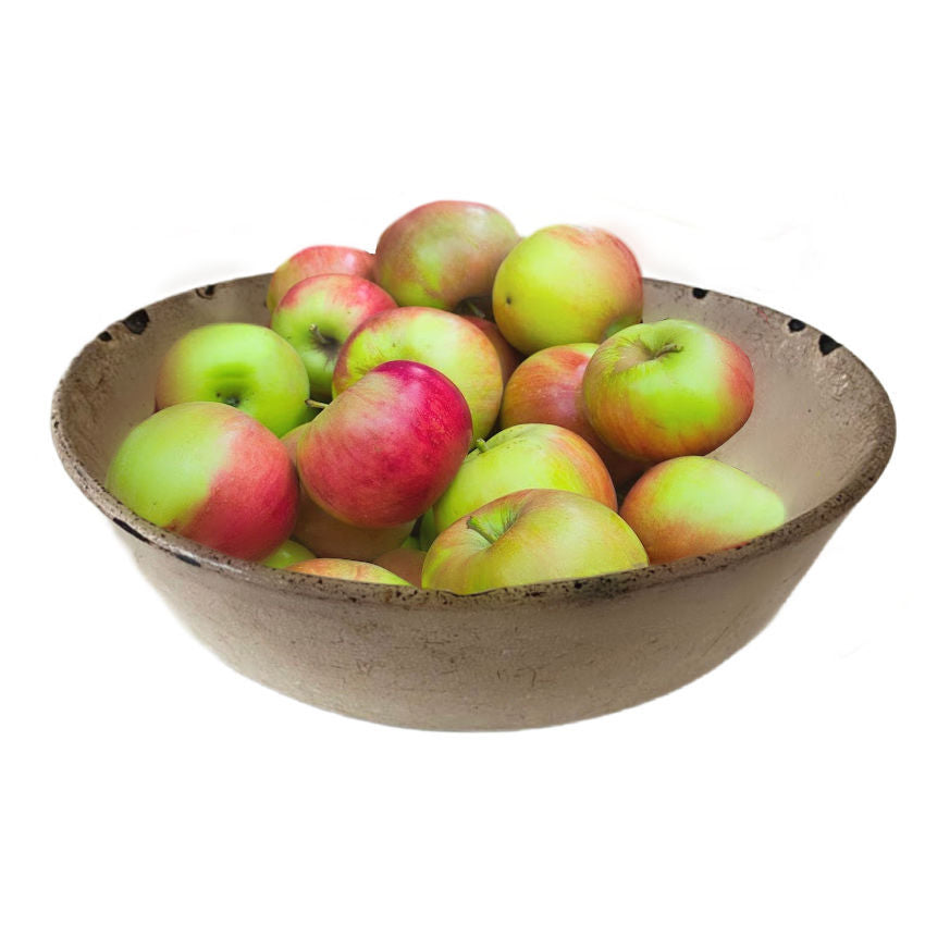 Antique French pottery Faience Bowl filled with red and green apples on a white background