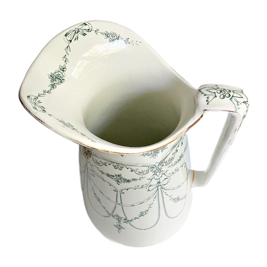 Antique Empire Rose Staffordshire Ironstone pitcher in teal green, English 19th-century tableware, elegant curved form and decorative rose garland and bow pattern.