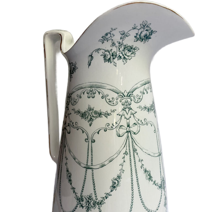 Close-up of teal green Empire Rose pattern on 19th-century Staffordshire ironstone pitcher, showing intricate Victorian hand-applied decoration.