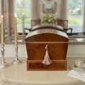 Antique English burl wood silverware chest styled on a dining room sideboard