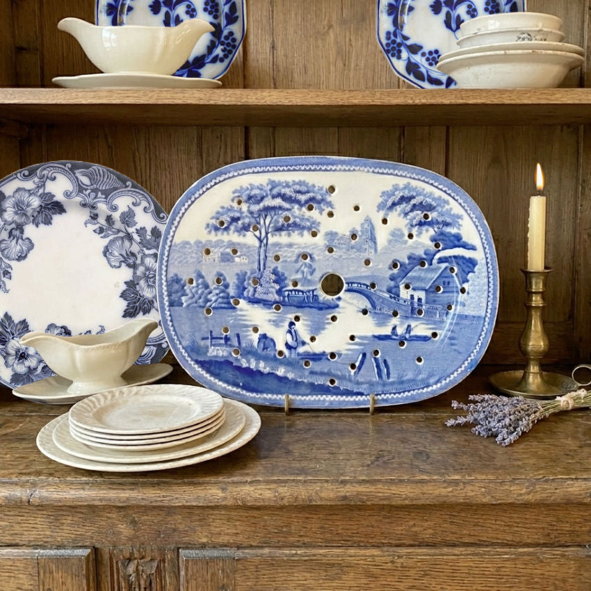 antique ironstone meat drainer displayed with blue and white collection