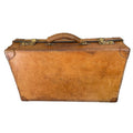 Antique English leather suitcase with warm patina and brass fittings Ralph Lauren Polo brass tag affixed