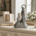 Antique French Art Deco Notre Dame de Lourdes Virgin Mary figure displayed on a cream painted French commode with antique books and white roses