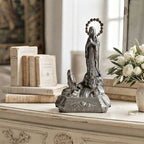 Antique French Art Deco Notre Dame de Lourdes Virgin Mary figure displayed on a cream painted French commode with antique books and white roses