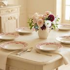 Antique French Athènes deep plates set on a table in a light-filled French country room
